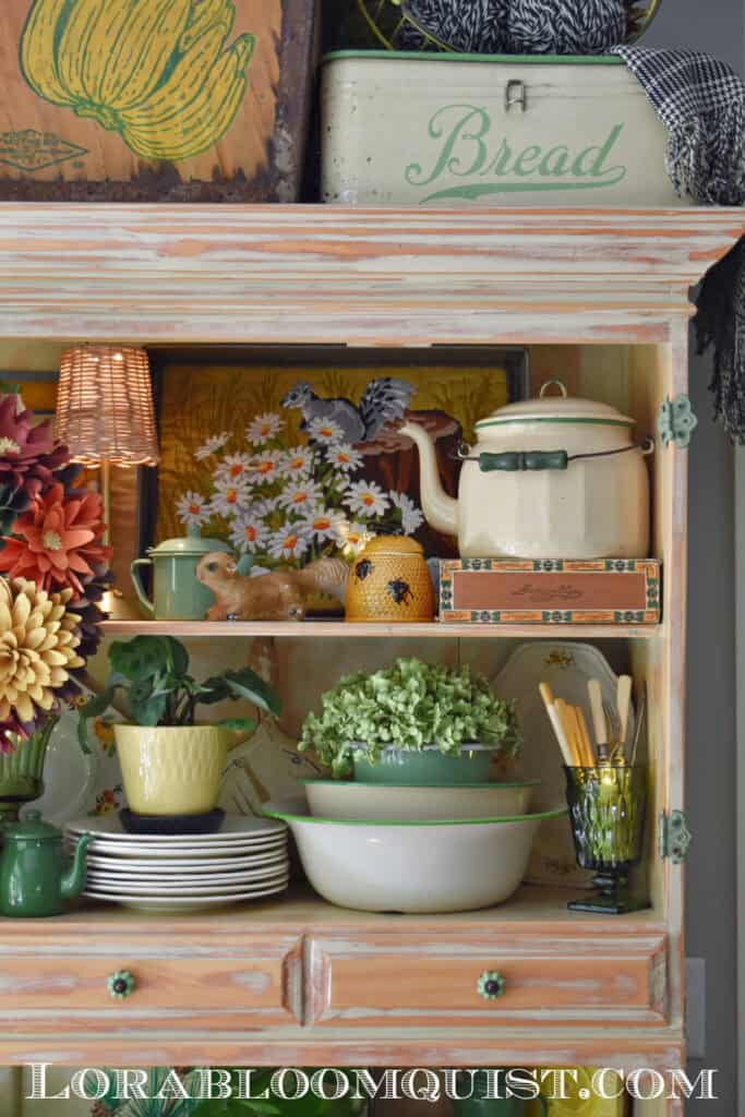 Green enamelware and vintage finds in a Fall hutch display.