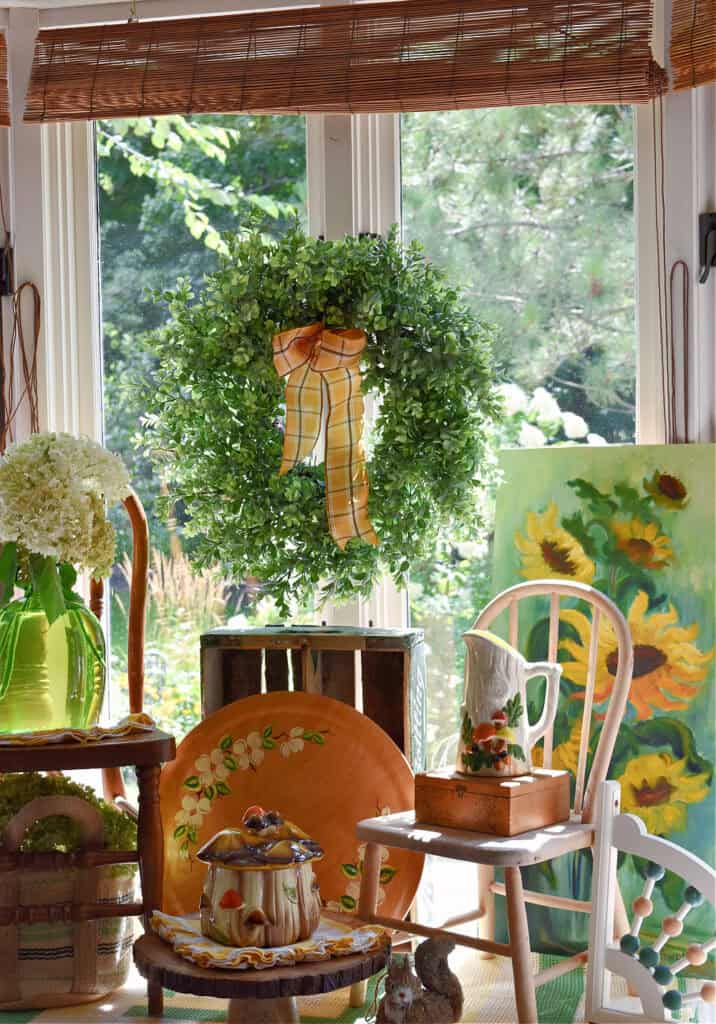 Fall colored vintage vignette with sunflowers and mushrooms.