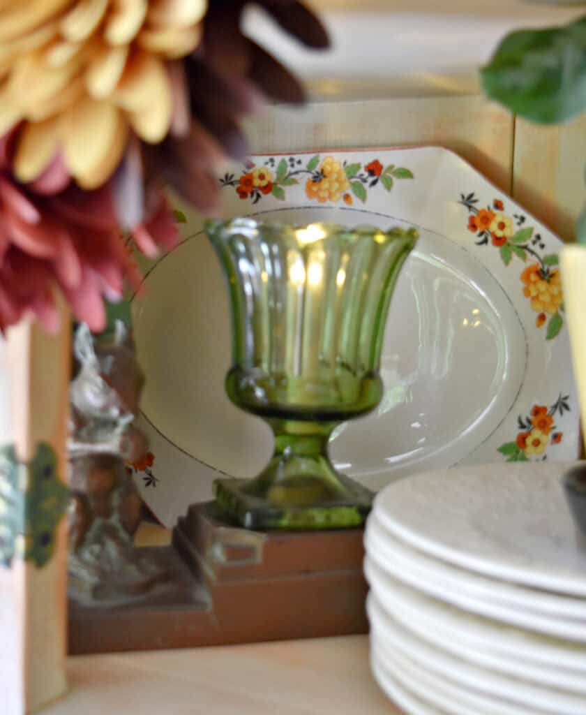 Fall colored floral plate in vintage vignette.