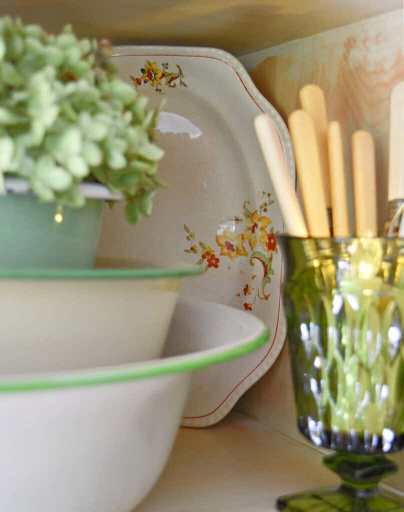 Fall colored floral plate in vintage vignette.