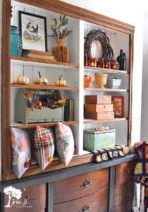 Fall colored accessories fill this cabinet display idea.