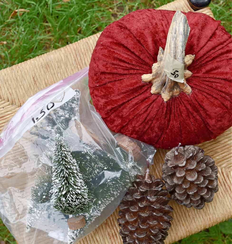 Thrifted seasonal decor: pumpkin, pinecones, brush trees.