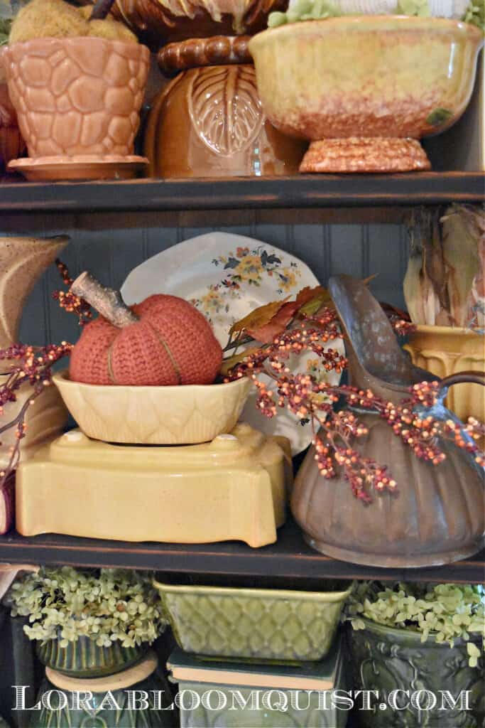 Fall colored vintage pottery collection display.