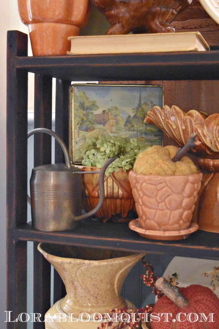 Fall display of vintage pottery with brass accents.
