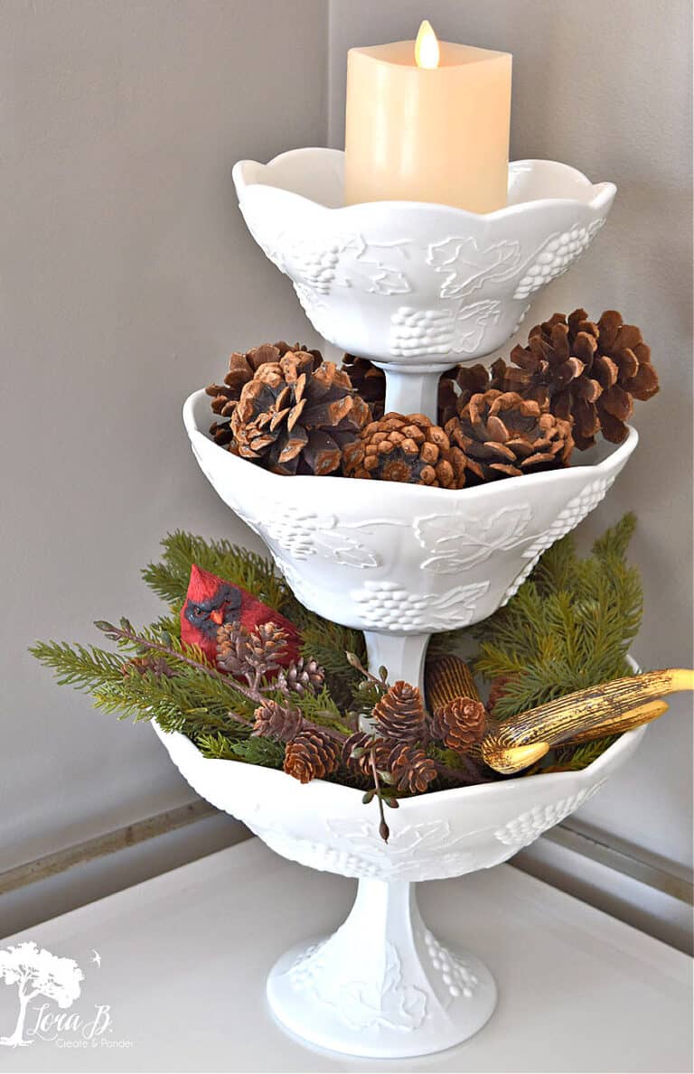 Pinecones and evergreens as winter decor filler in milkglass vessels.