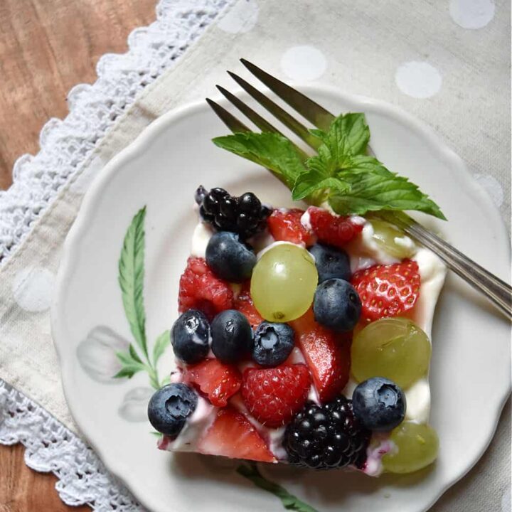 Fruit pizza square on plate.
