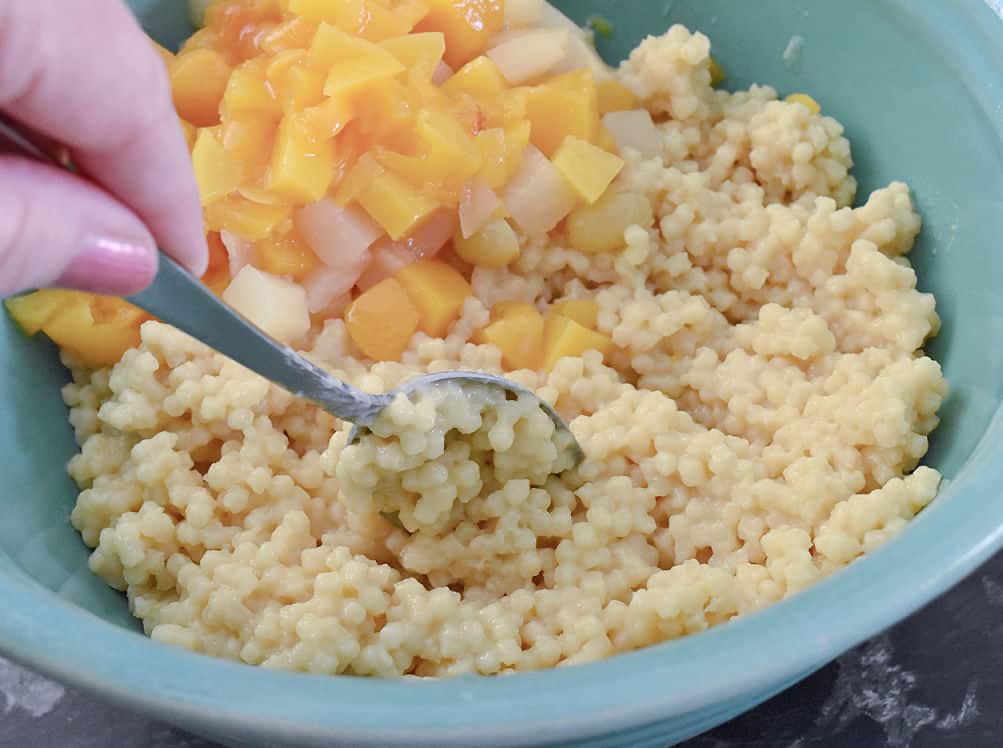 Mixing noodle balls into fruit salad