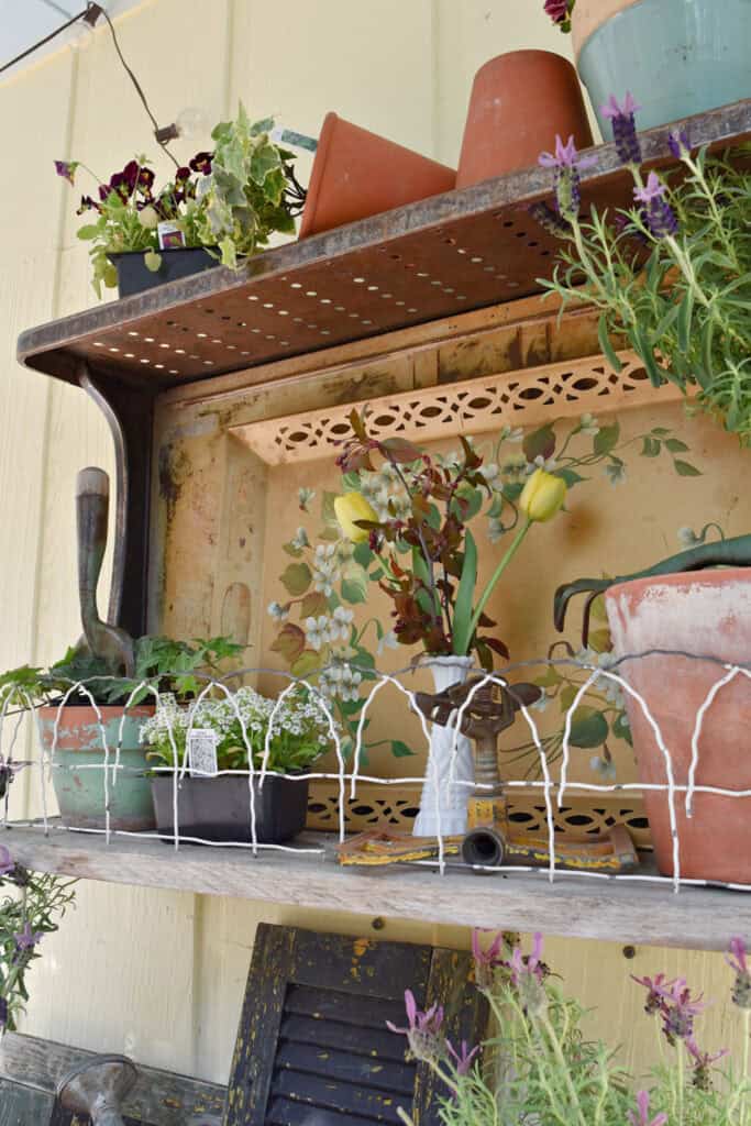 Upcycled vintage stove shelf with gardening theme display.