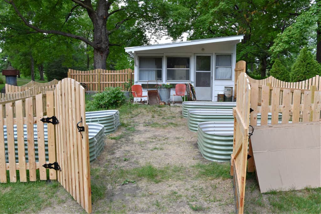 Custom picket fence garden with raised beds.