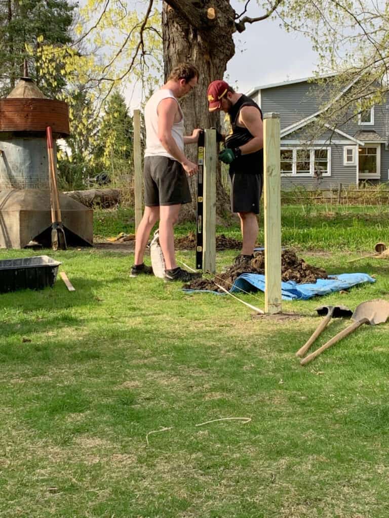 Putting in fenceposts.