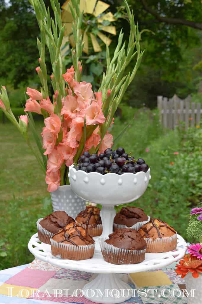 Milk glass cake plate and footed bowl stacked as serving pieces.