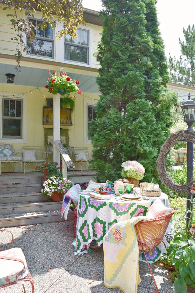 Yellow farmhouse with pretty garden party table setting.