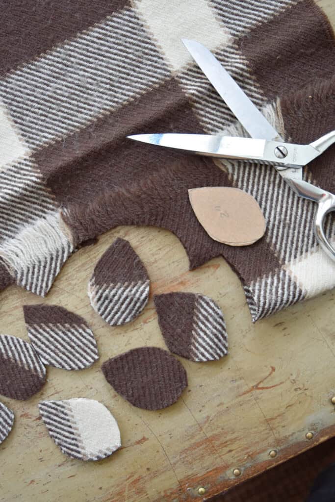 Cutting scrap fabric leaves.