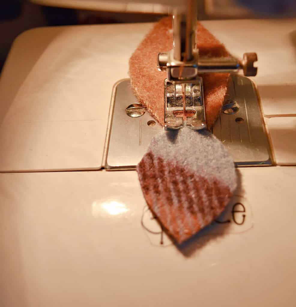 Sewing wool fabric into leafy garland.