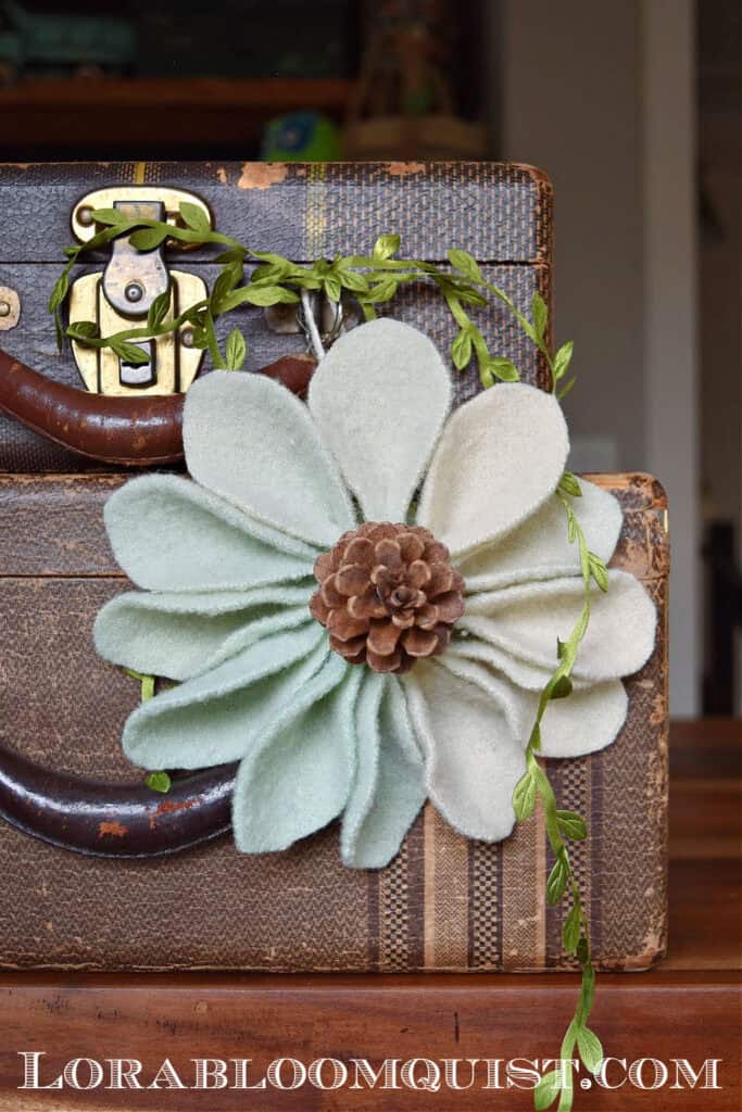 Scrap fabric ornament hung on suitcases.