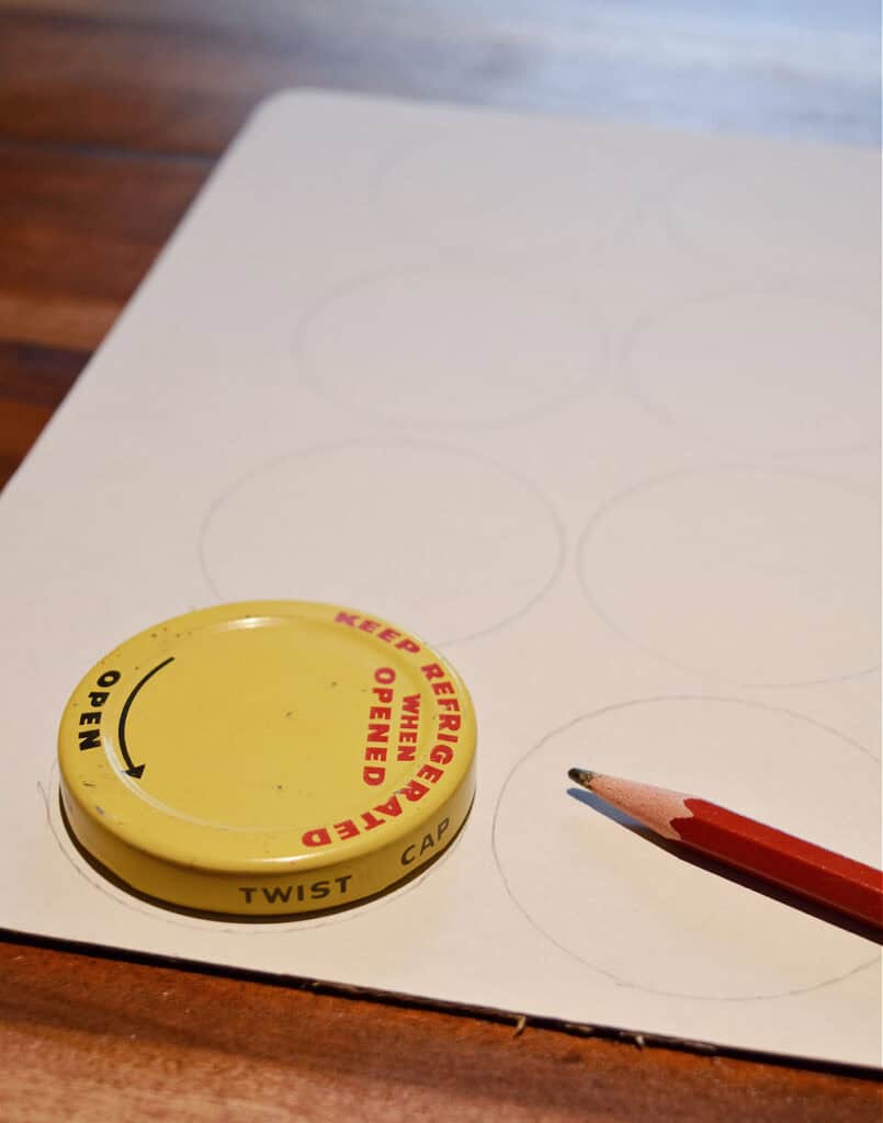 Tracing an old lid for homemade ornaments.