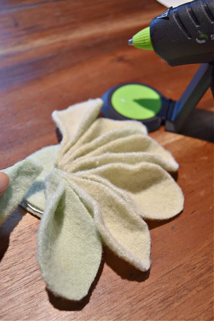 Gluing fabric petals to DIY gift topper.