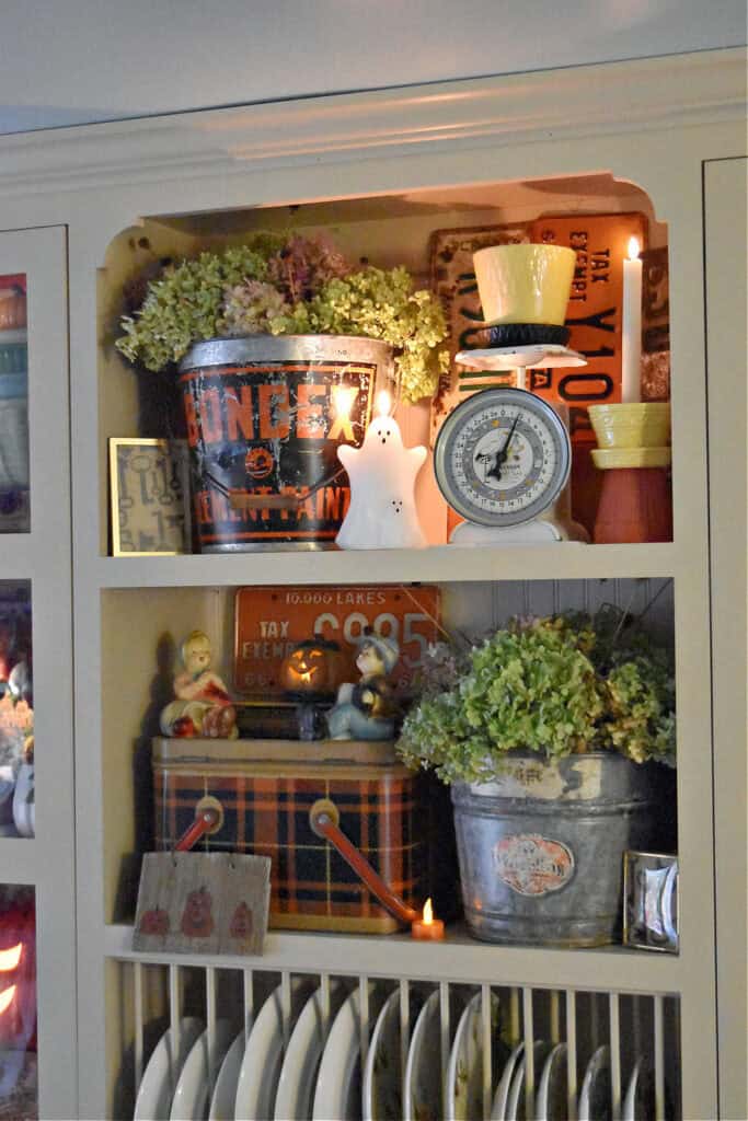 Vintage metal buckets and plaid picnic basket as Fall decor display.