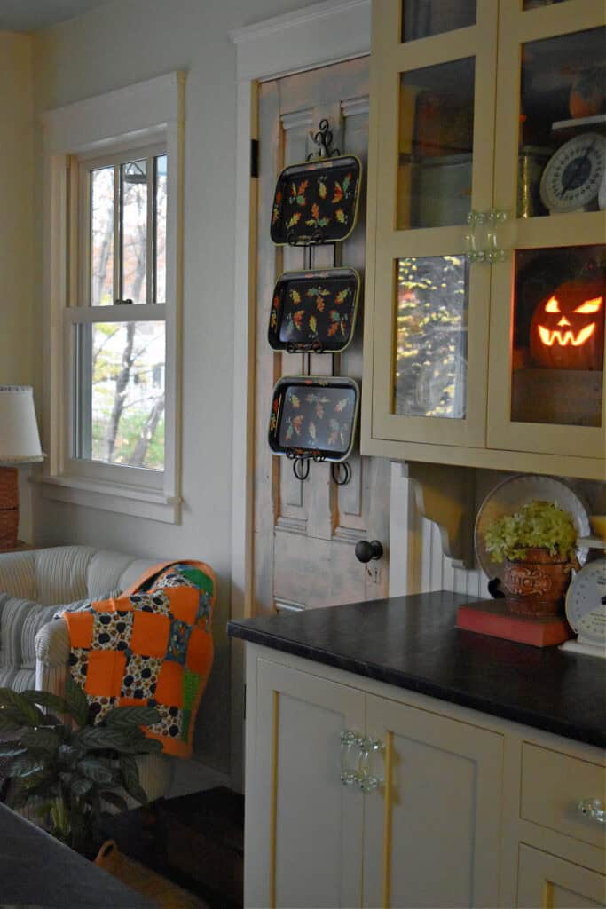 Vintage fall trays as decor in an autumn decorated kitchen.