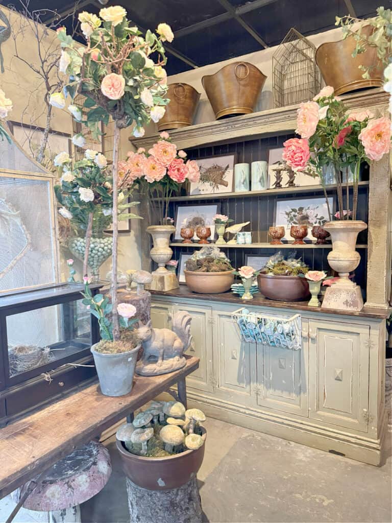 Floral and gift shop display with pink peonies.
