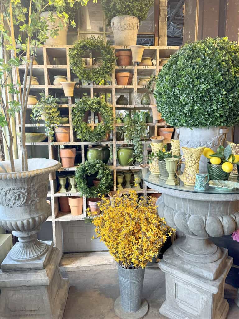 Floral gift shop display with concrete urns.