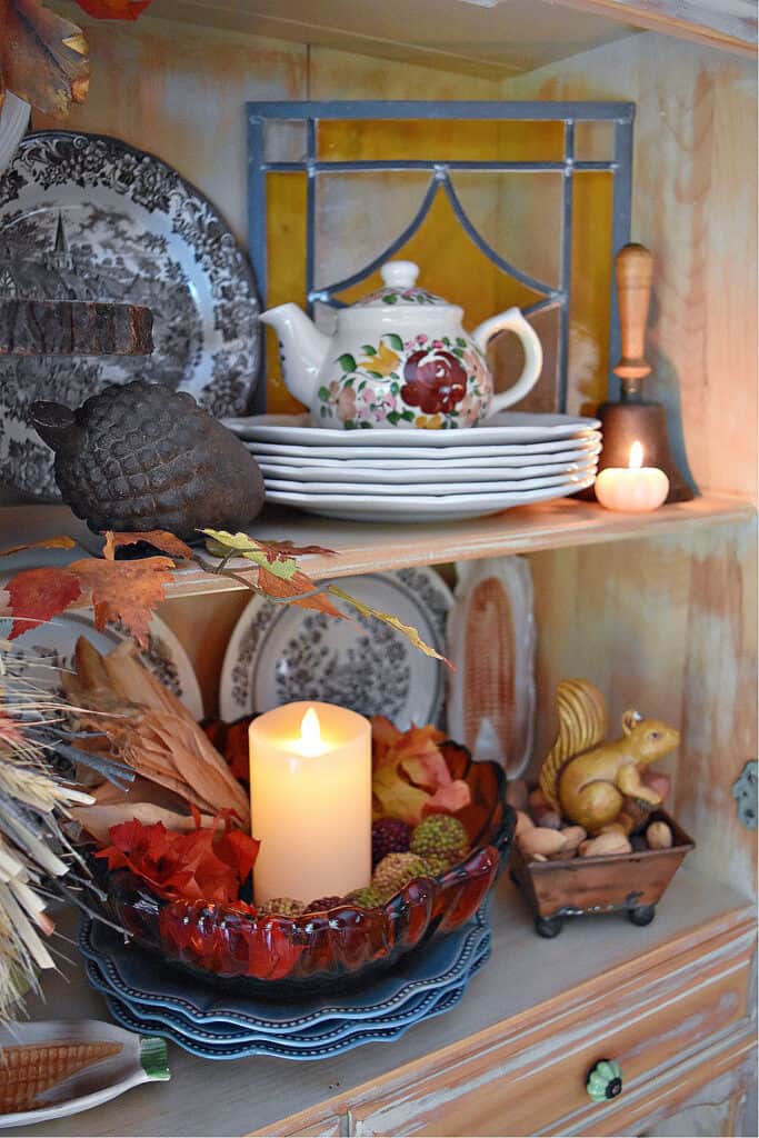 Fall decorated hutch with rustic natural decor.