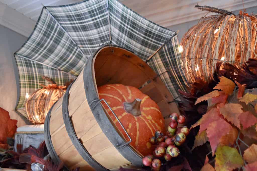 Pumpkins and bushel baskets as hutch decor.