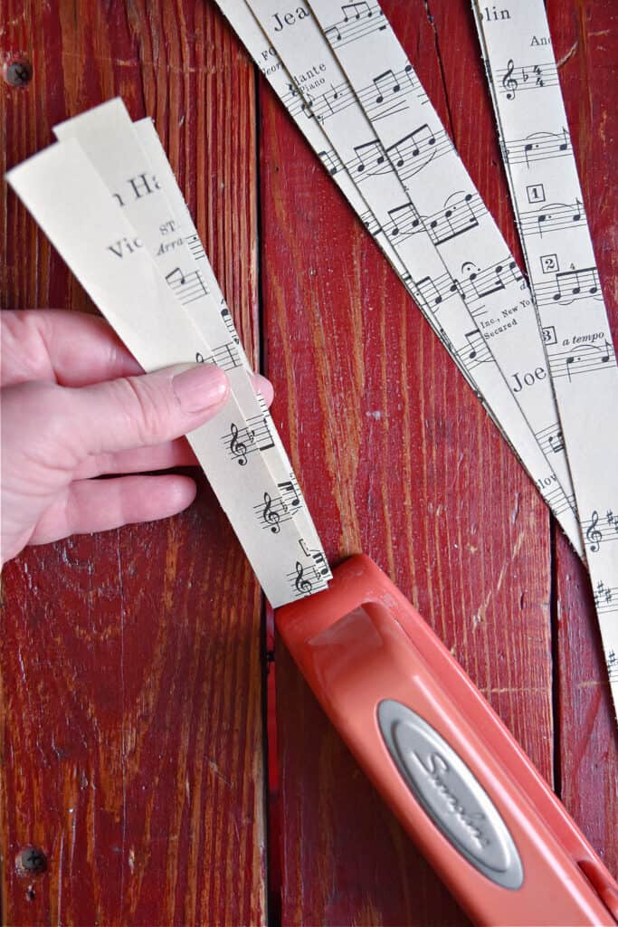 Crafting DIY paper heart garland with vintage music.