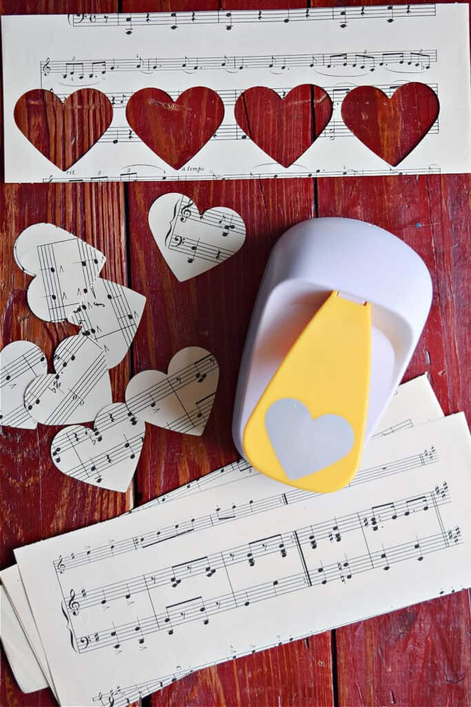 Heart paper punch and vintage music to make DIY paper heart garland.