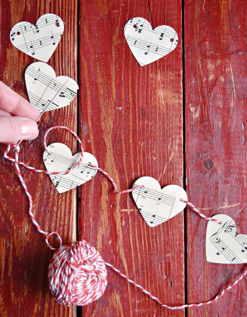 Crafting DIY paper heart garland with vintage music.