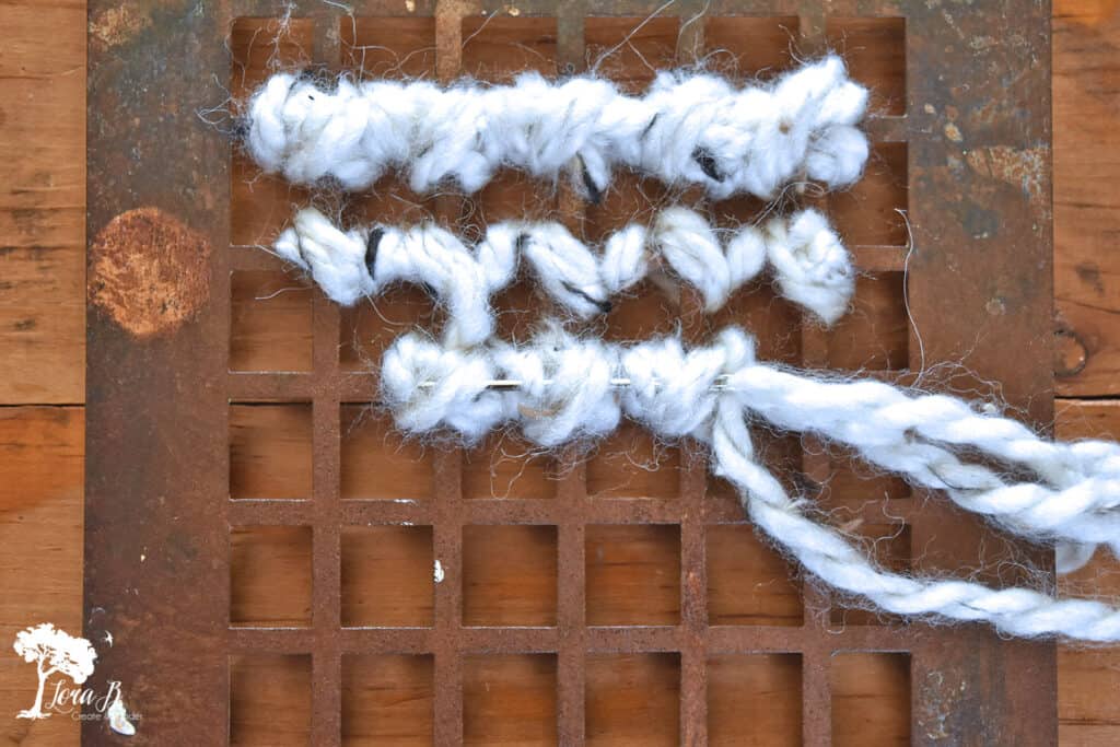 DIY yarn art on old heat grate as Christmas decor