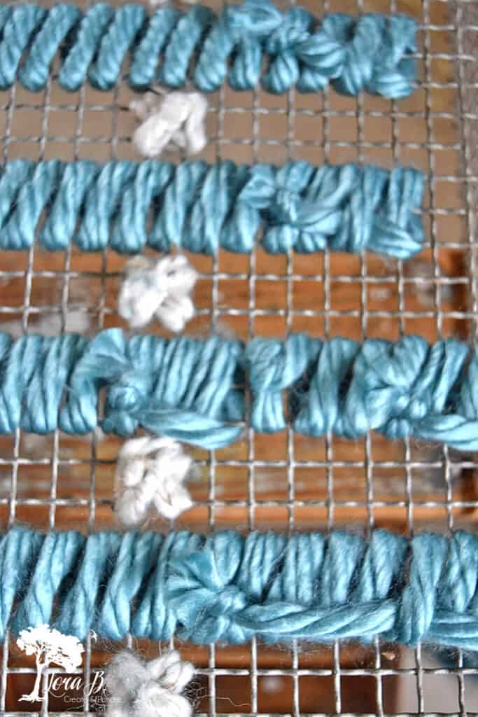 DIY yarn art on old heat grate as Christmas decor