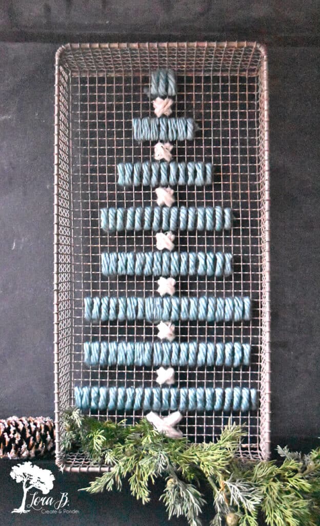 DIY yarn art on old heat grate as Christmas decor