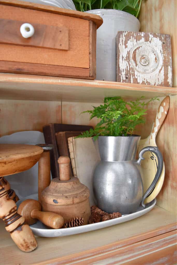 Neutral accessories in hutch decor.