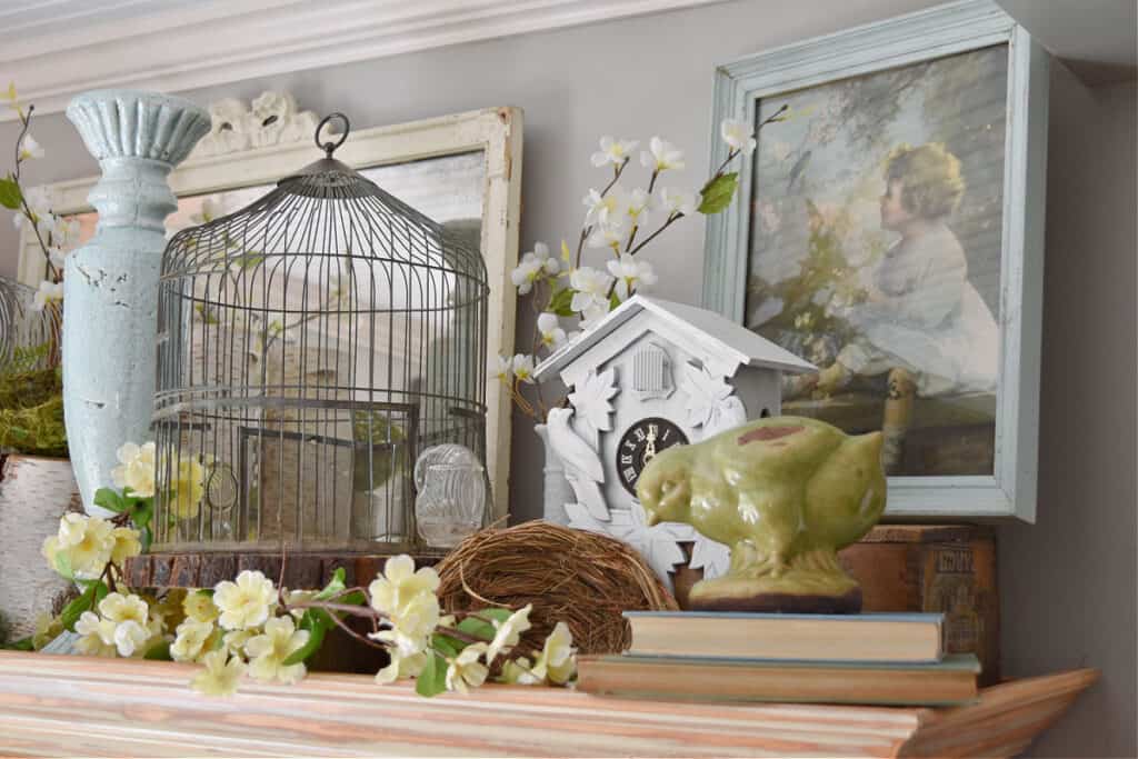 Spring decorated hutch top with vintage birdcage.