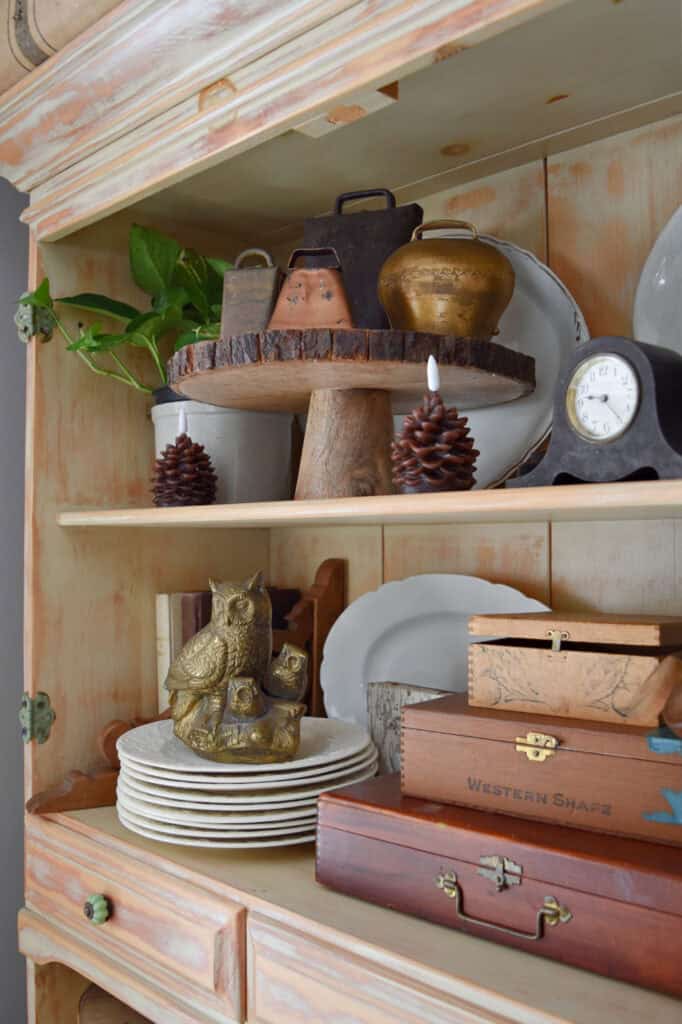 Vintage neutral accessories in hutch decor.
