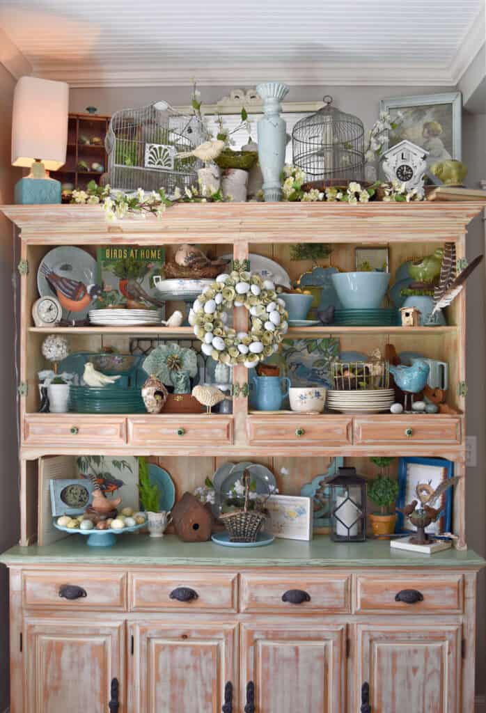 Spring decorated hutch with an aqua bird theme.