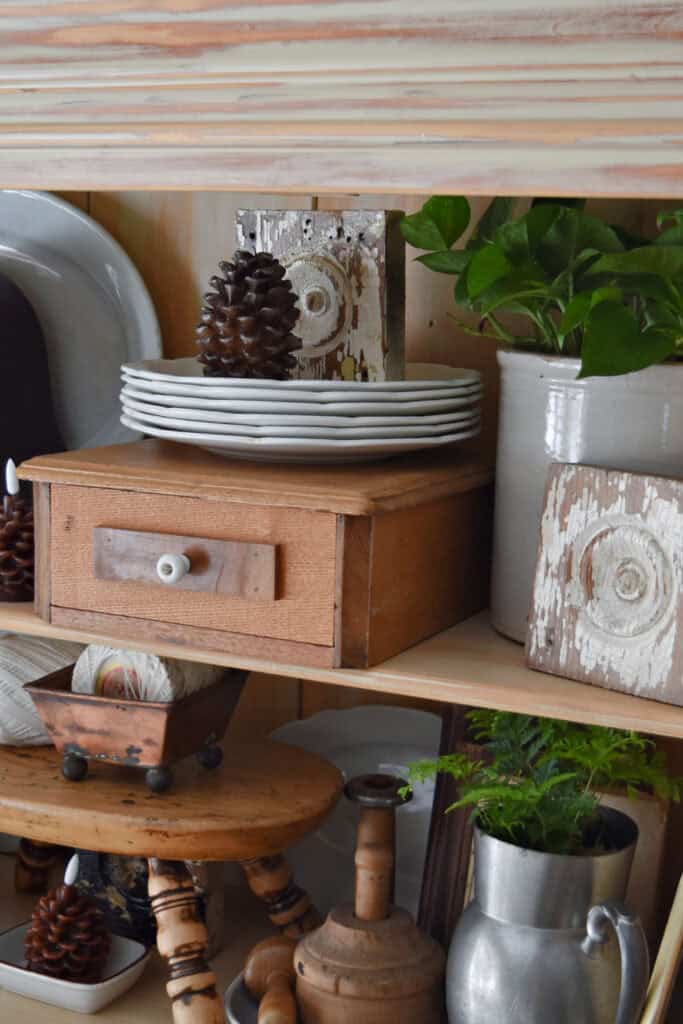 Neutral vintage accessories in hutch decor.