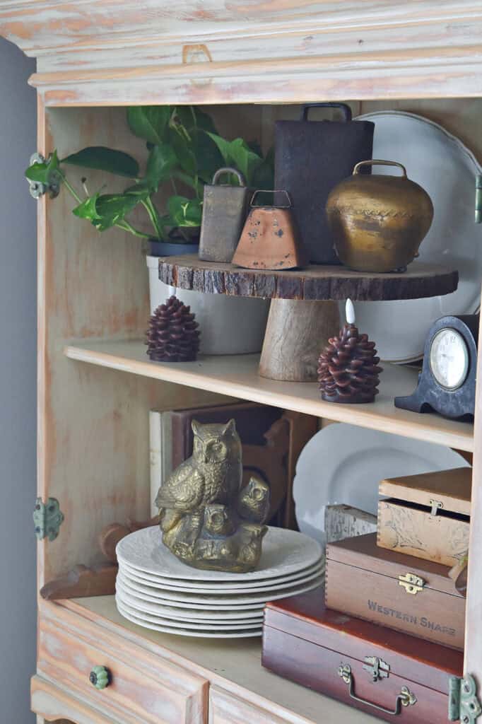 Mixed metal accessories on bookshelves.