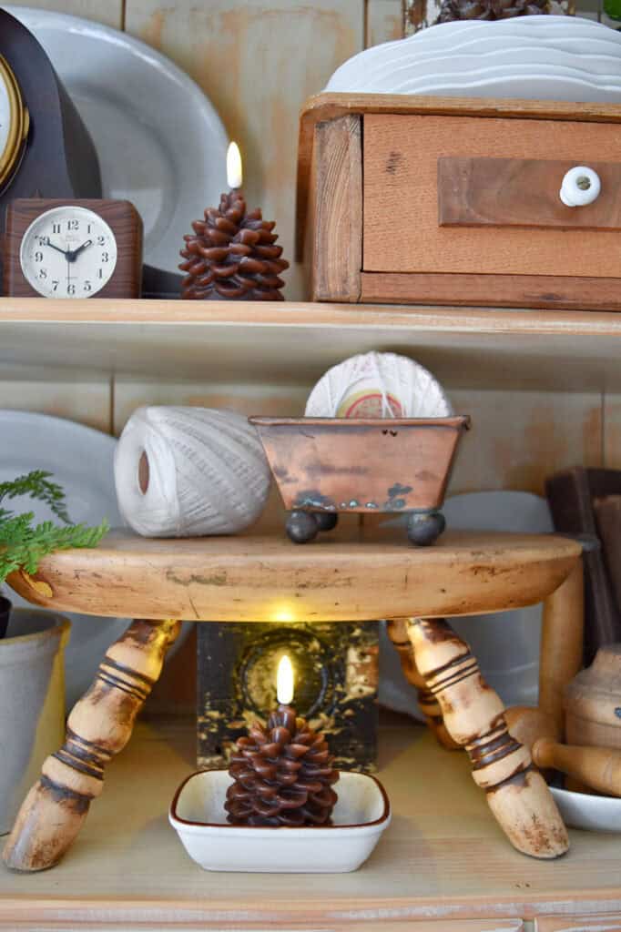 Neutral vintage accessories on shelf.