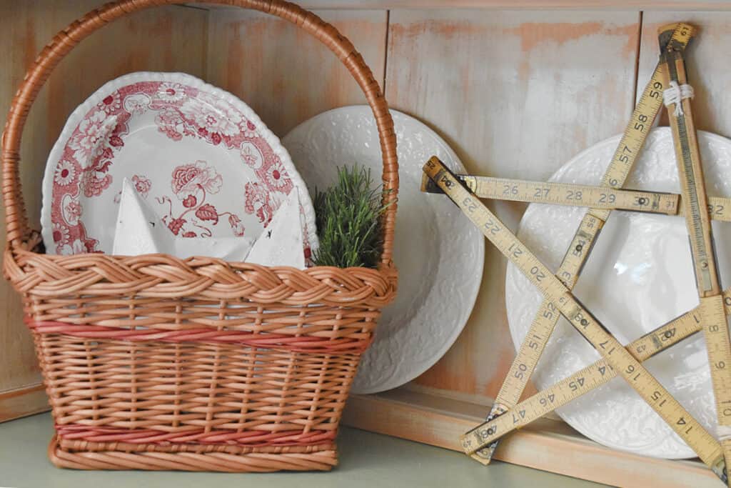 DIY vintage ruler star and old plates in basket decor.