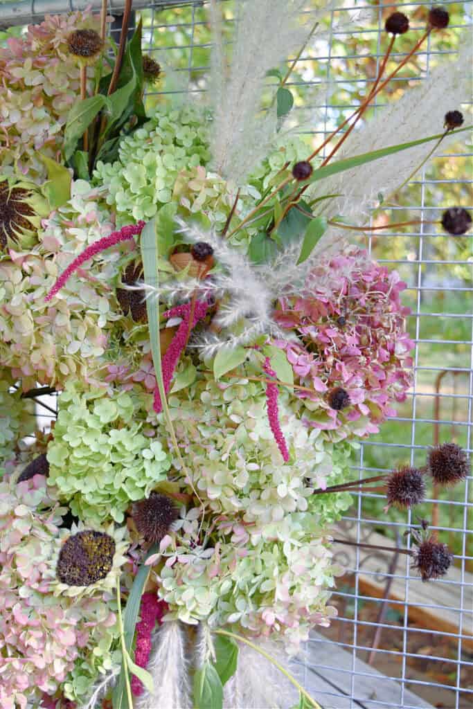 Fresh hydrangea and garden flowers on wreath.