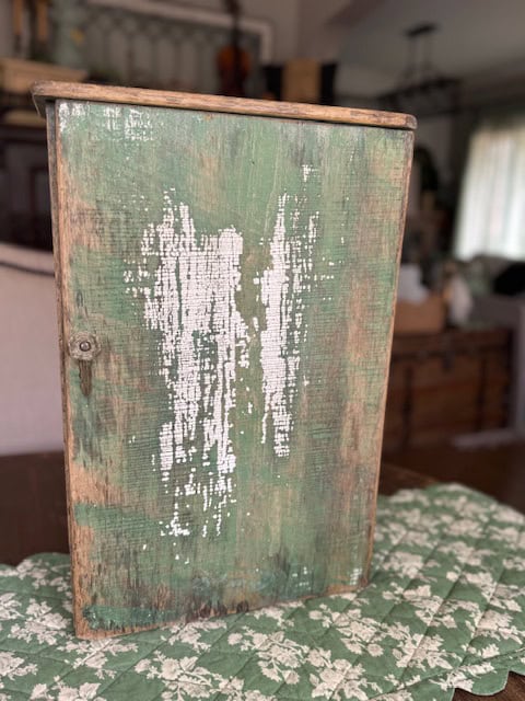 Vintage chippy green little cabinet.