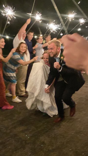 Bride and groom running through sparkler send off.