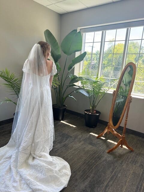 Bride looking in mirror.