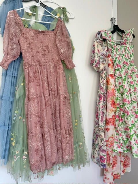 Floral bridesmaid dresses hanging.