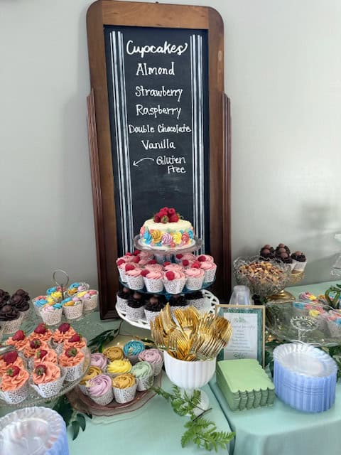 Cupcake buffet for wedding with chalkboard menu.