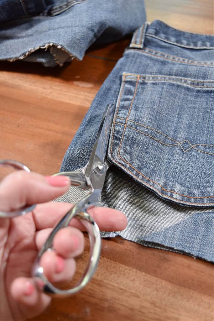Cutting jeans to make jean pocket garland.