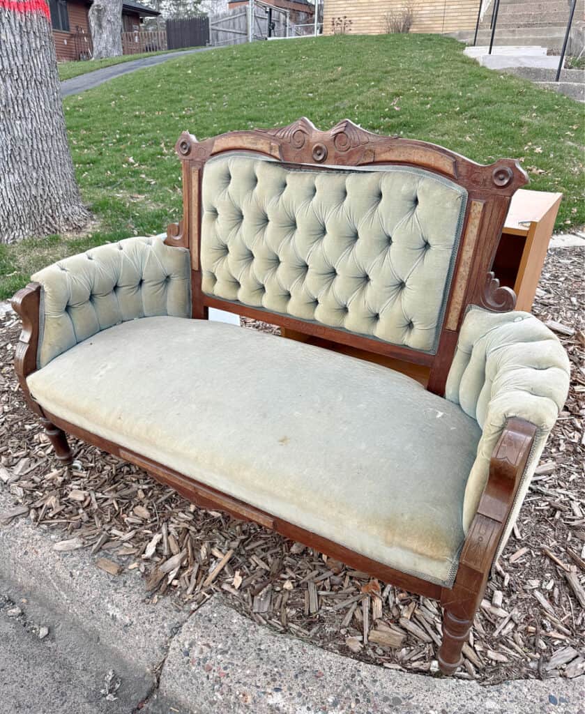 Vintage button tufted velvet settee in curbside pile.