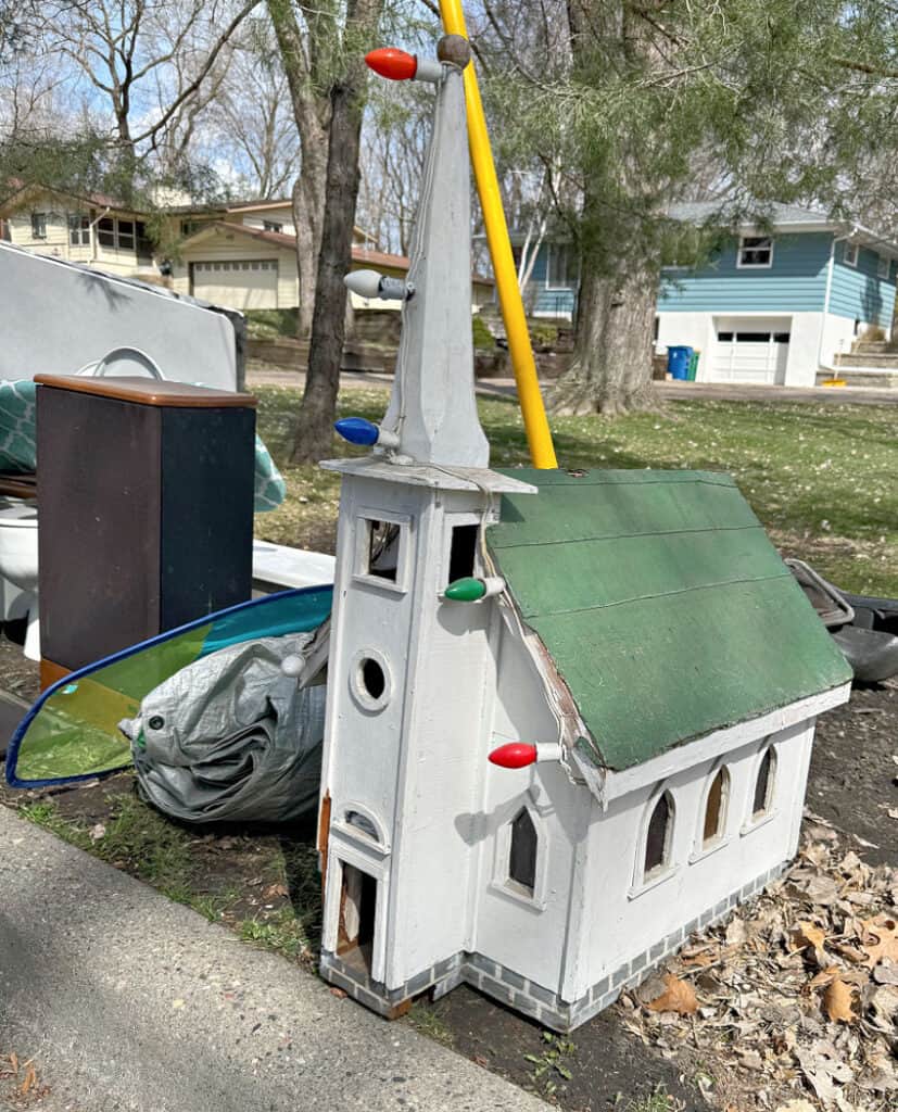 Handmade church in curbside pile.